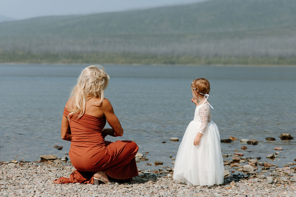 A couple's daughter frolics along the shores of Avalanche Lake before her parents' intimate wedding ceremony