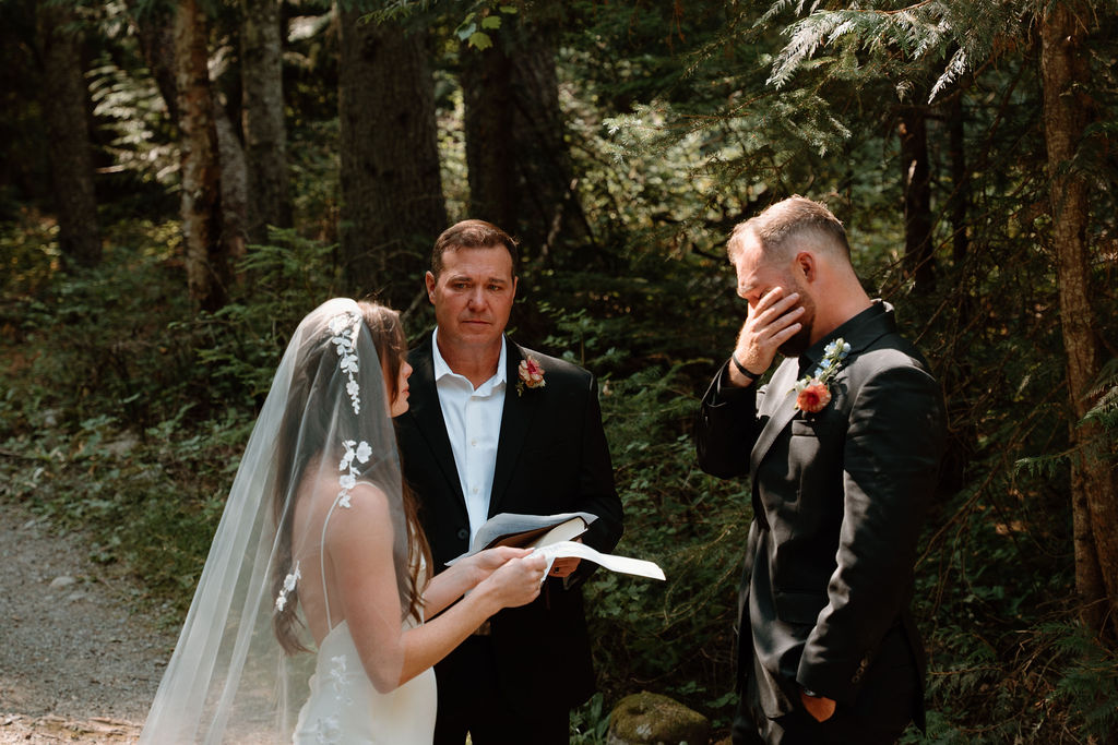Bride and groom exchange emotional heartfelt vows during their Avalanche Lake Amphitheater wedding ceremony