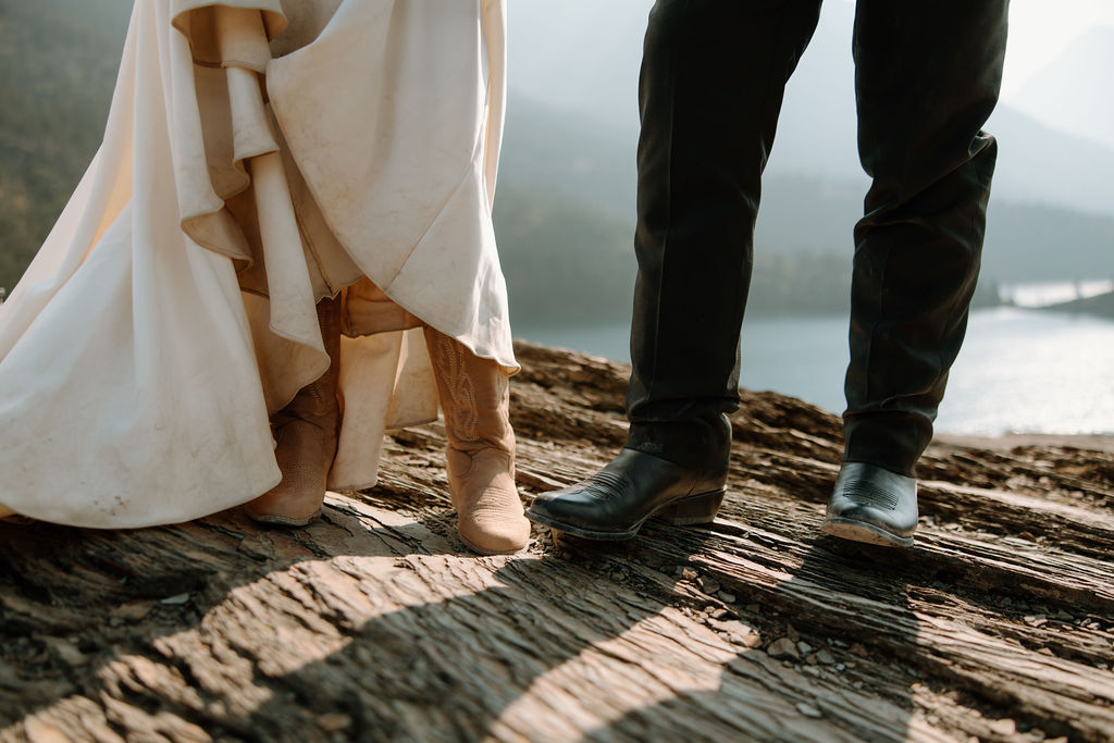 Newlyweds show off their cowboy boots that they wore for their Glacier National Park elopement
