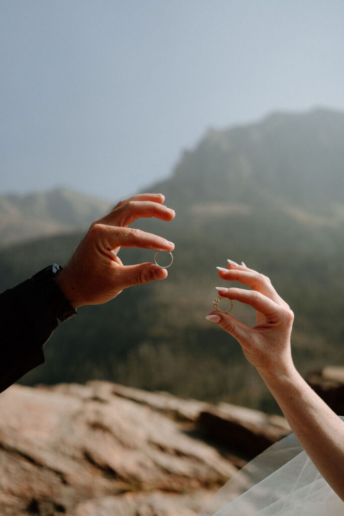 Newlyweds show off their new wedding bands during bridal portraits in Glacier National Park