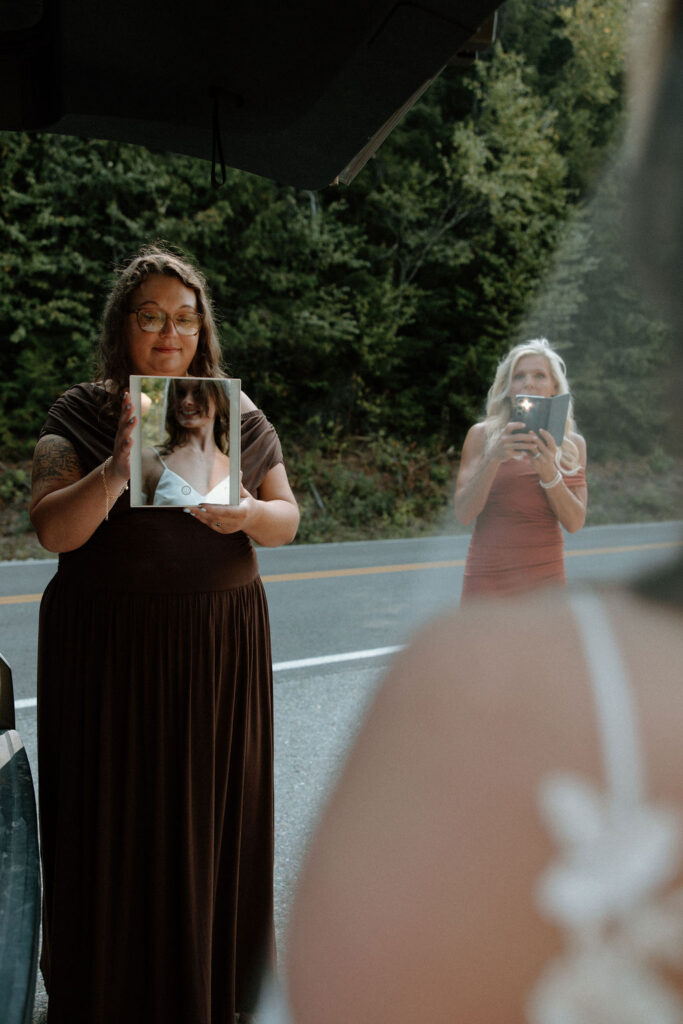 Bridesmaids help a bride get ready for her Avalanche Lake Amphitheater intimate wedding